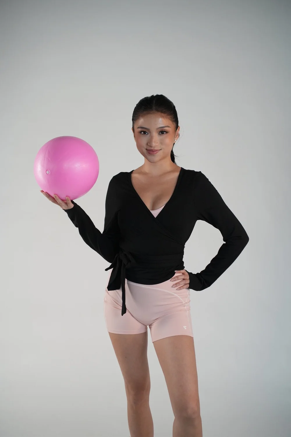 Elara wrap top layered over a studio outfit