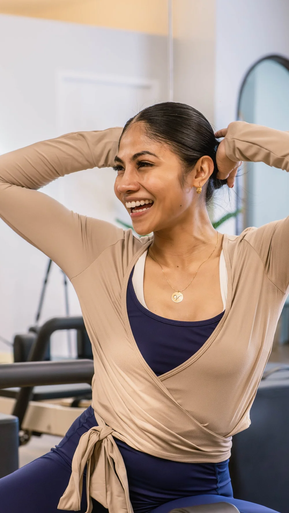 Elara wrap in sand worn in the Pilates studio